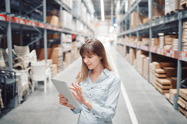 Woman standing holding tablet 